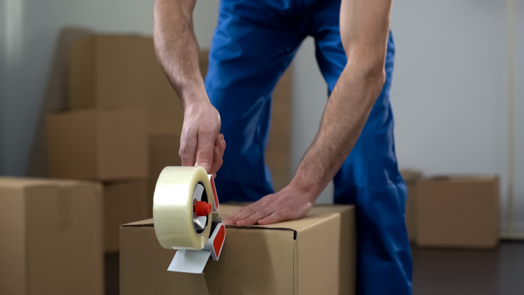 Man packing up boxes - how much do house removals cost in the UK?